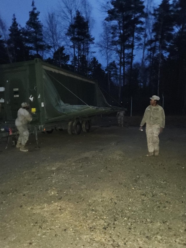 Soldiers assemble a containerized kitchen (CK).