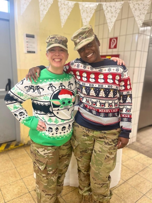 Soldiers pose wearing Christmas sweaters.