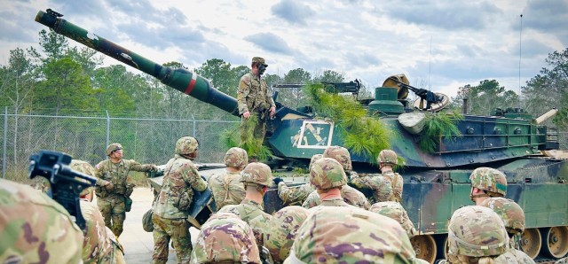 SSG Tanner Leigh provides a survivability and camouflaging block of instruction to Class 24-001 to prepare both personnel and equipment to avoid detection from sUAS during the Ten-Day War.