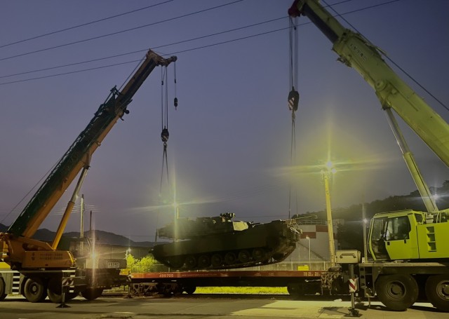 Cranes provide support to unload tanks at the Camp Casey Railyard, August 2023.