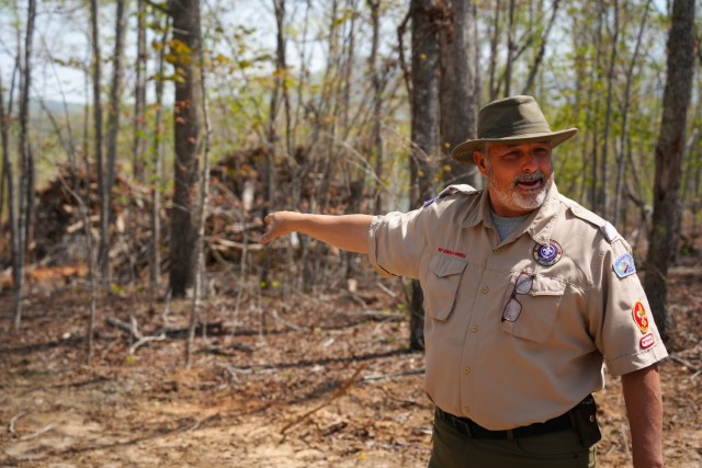 Camp Ranger Troy Williams points to a pile of debris gathered for removal at Camp Grimes in McDowell County, North Carolina., April 18, 2025. The U.S. Army Corps of Engineers is leading debris removal operations at the 1,100-acre Boy Scout camp as...