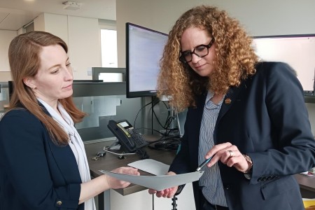 Stefanie Poulsen confers on a project with Emily Babbitt de Nicasio, chief of the Energy, Environment, and Utilities Branch at IMCOM-Europe.