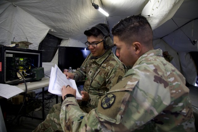 Sgt. Jomary Aying, a Combat Net Radio non-commissioned officer with 13th Armored Corps Sustainment Command and Spc. Jose Urbina, a Network Operations Technician with 86th Expeditionary Signal Battalion, attempt to create a channel for...