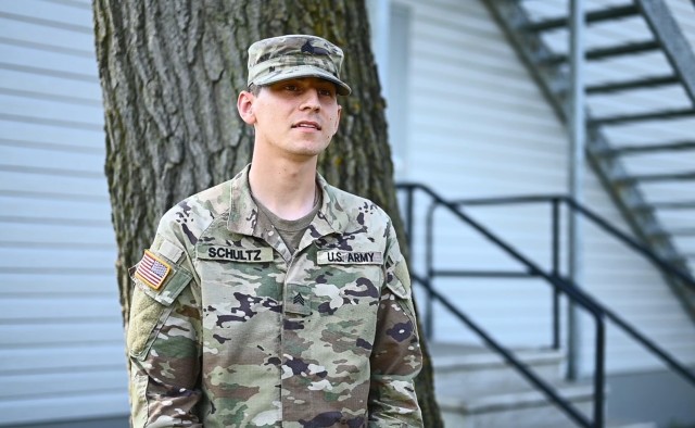 Sgt. Korbein Schultz, an intelligence analyst for 720th Military Police Battalion, 89th Military Police Brigade, discusses coordinating the support of linguists with Afghans as part of the Task Force McCoy mayor cell at Fort McCoy, Wisconsin, Aug....