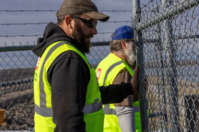 Maintenance Mechanics Paul Burghart (left) and Mark Saffle (right) opening the gates to Hillsdale Dam and reservoirs intake control tower for members of the inspection team to do their assessments on components and systems inside the structure.