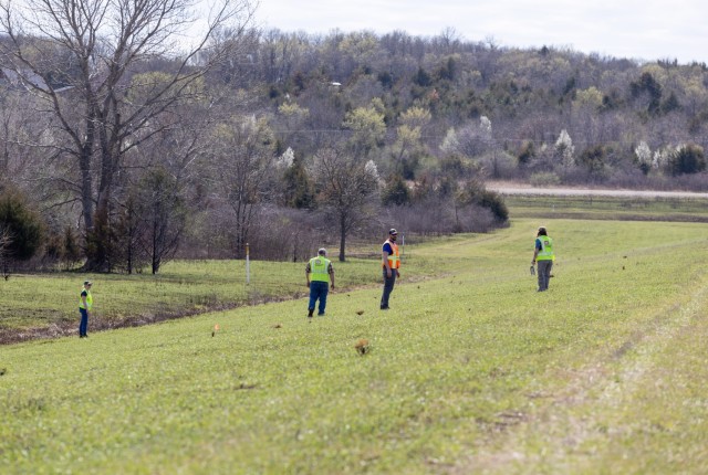 Several members of the Hillsdale reservoir periodic inspection team surveying the dike system connecting the dam bridge and upstream embankment to the spillway.