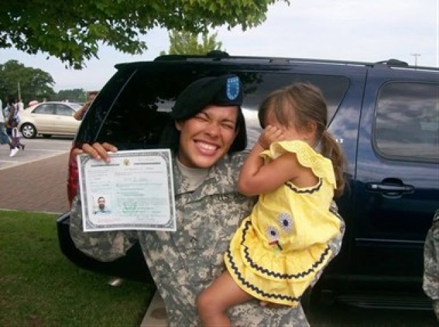 Me showing off my naturalization certificate and cheesy grin June 14, 2010, in Fort Jackson, S.C., while my daughter, Kailynn, who was 3 at the time, hides from the camera