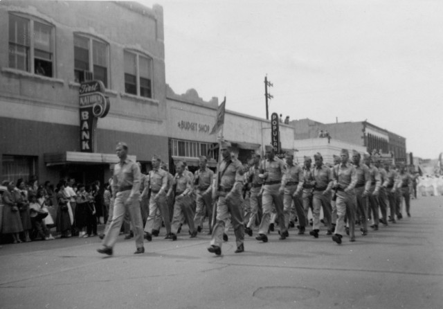 Photo shows Army Soldiers from White Sands Proving Ground marching in parade down Main Street in Las Cruces, New Mexico.