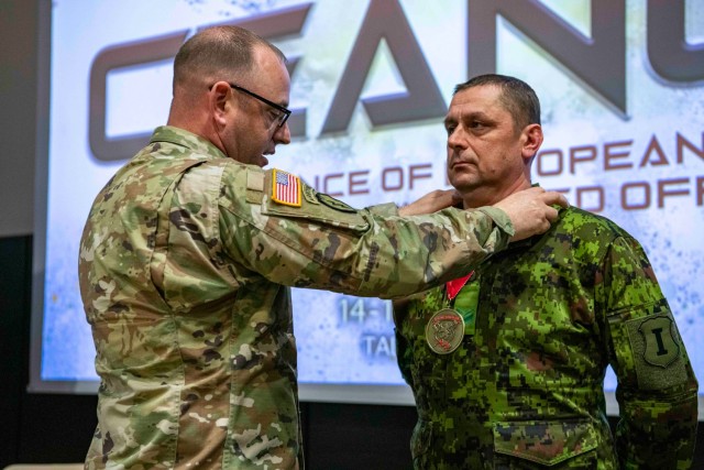 U.S. Army Sgt. Maj. Aaron Spahl (left), operations sergeant major, U.S. Army Europe and Africa, presents the Sergeant Morales Club medallion to Command Sgt. Maj. Andreas Rebane (right), command sergeant major, Estonian Division, during the...