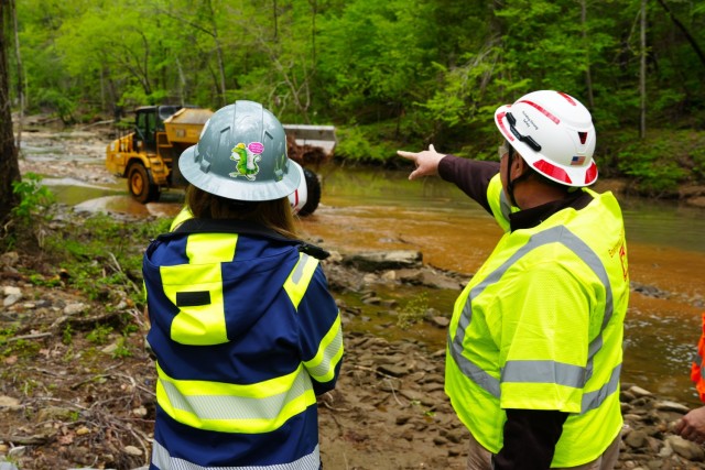 Acting Assistant Secretary of the Army for Civil Works, Lee Forsgren (right), points toward equipment performing waterway Hurricane Helene debris removal on the Broad River near the town of Lake Lure, North Carolina, on April 25, 2025, as he asks...