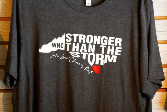 A shirt is seen hanging from the wall at a local business in Chimney Rock, North Carolina, April 16, 2025. The shirt reads “Stronger than the storm: Lake Lure / Chimney Rock”, highlighting the resiliency of the two communities deeply impacted...