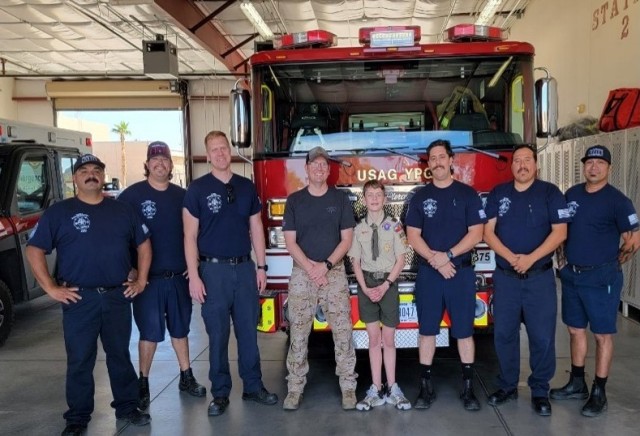 Boy Scout pictured with Yuma Proving Ground Firefighters