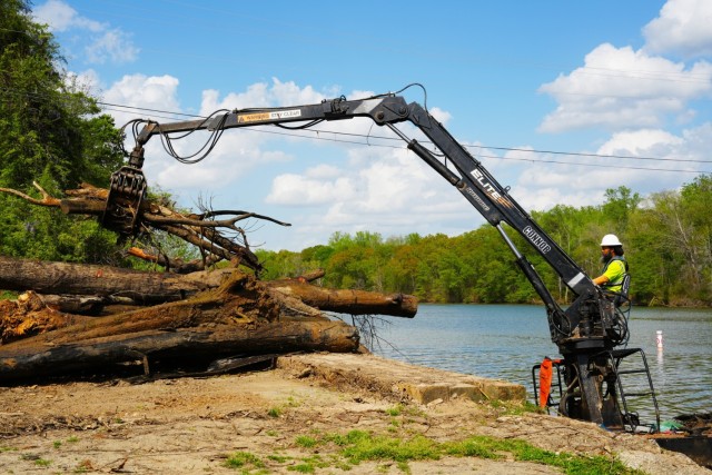 Contractors remove debris from Dutchmans Creek in Mount Holly as part of Hurricane Helene recovery efforts