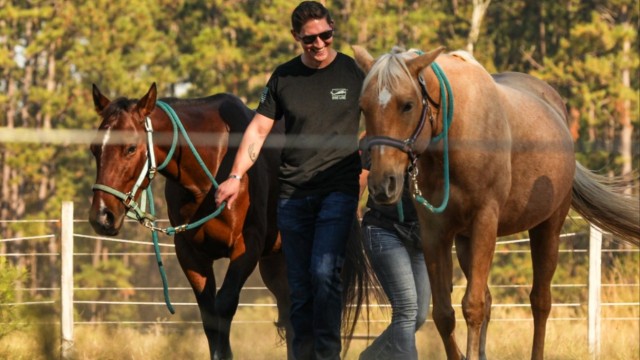 U.S. Army Warrant Officer Jarred Albertson, a health services maintenance technician with the U.S. Army Medical Department Activity, led two horses during an equine therapy session at Fort Stewart, Georgia. The goal of the sessions is to...