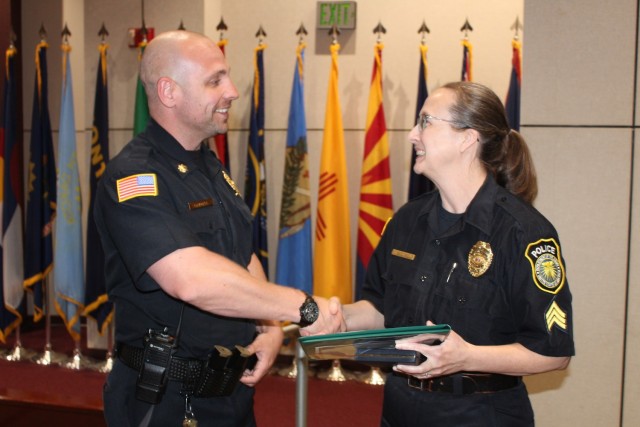 Police Maj. Derek Campbell, the Redstone Police Officer of the Year for 2024, congratulates Police Sgt. Catherine Ritchey. She received a Civilian Service Achievement Medal during the quarterly Garrison awards ceremony April 25 at Bob Jones...