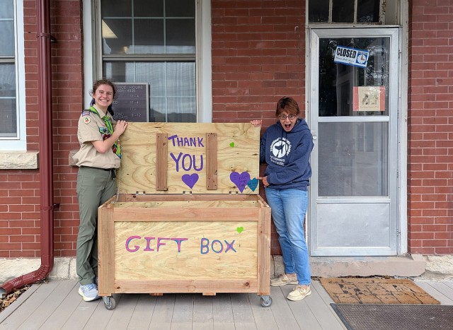 Eagle Scout candidate Elizabeth Faught delivers a drop-off box, accepted by Fort Leavenworth Stray Facility volunteer Cathy Schrankel, April 26, 2025, at the stray animal facility at Fort Leavenworth, Kansas. The larger box replaces a small red...