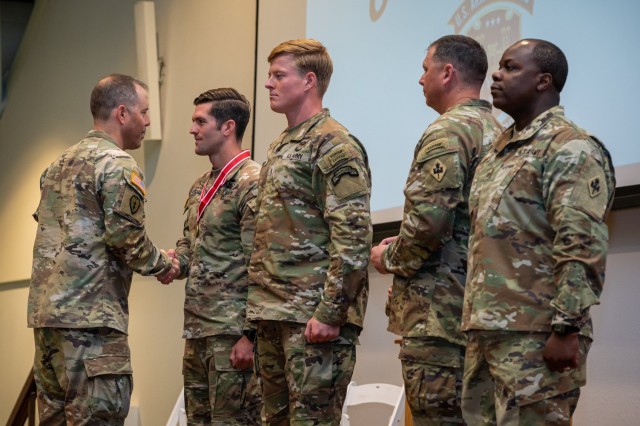 2025 Best Sapper winners, Capt. James Mitchiner and 1st Lt. George Madden with the 75th Ranger Regiment, in Fort Benning, Georgia, receive the Meritorious Service Medal and Bronze de Fleury from Col. Stephen Kolouch, U.S. Army Engineer School...