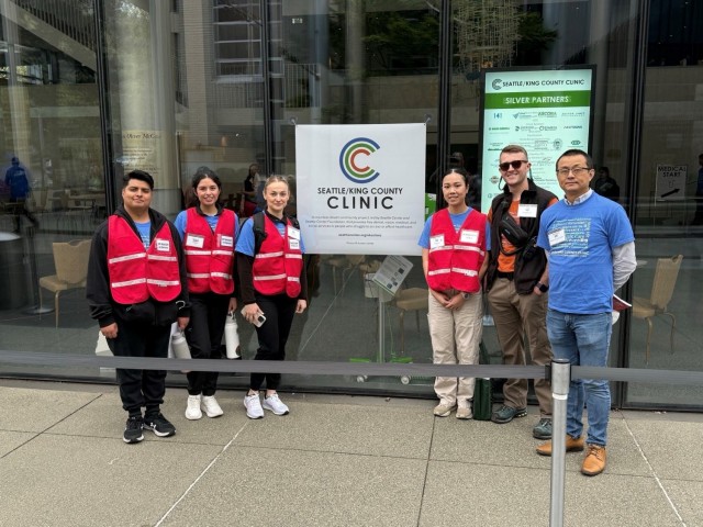 Group photo of Delta Company, 341st Military Intelligence Battalion soldiers standing in front of the Seattle / King County Clinic.