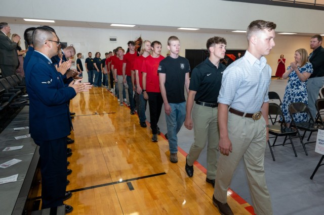 Attendees stand and applaud as future military members enter Waynesville High School gym April 30 during the 2025 Community Salute to Service event.