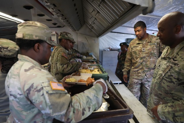 U.S Army Spc. Satchel Hill, left, a culinary specialist assigned to the 5001st Field Feeding Company, 167th Theater Sustainment Command, Alabama Army National Guard, serves breakfast to Antigua and Barbuda Defence Force Sgt. Tashika Riley during...