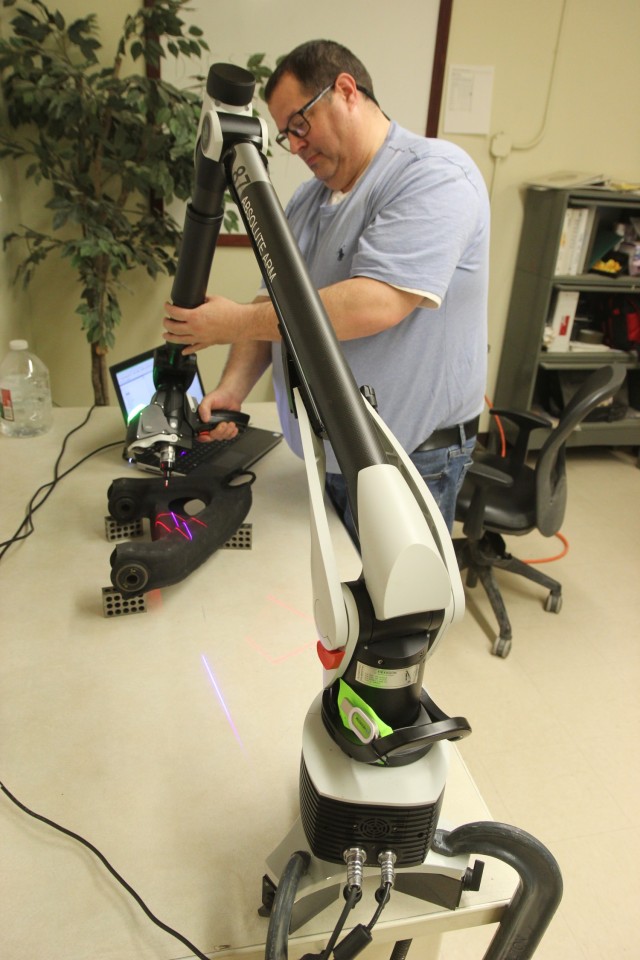 Kevin Thomas, from DEVCOM GVSC, scans a part for Battle Damage Repair and Fabrication.