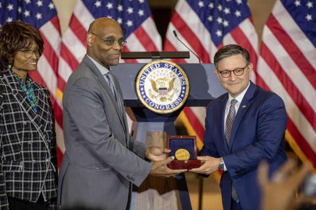 Speaker of the House, Rep. Mike Johnson (R-La.), presents the Congressional Gold Medal to Stanley Earley III, son of 6888th Central Postal Directory Battalion commander Lt. Col. Charity Adams Earley, during a ceremony in Emancipation Hall at the...