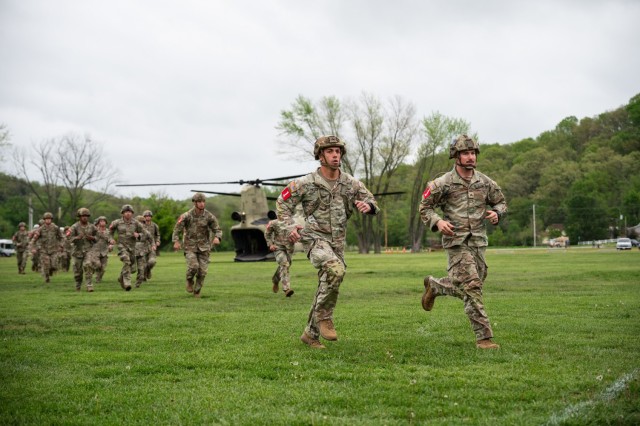 1st Lt. John Pezzolanti and Sgt. Elias Geary, with the 1st Armored Brigade Combat Team in Fort Riley, Kansas, lead a pack of competitors charging toward the start line of the 2025 Best Sapper Competition’s nonstandard physical fitness test April...