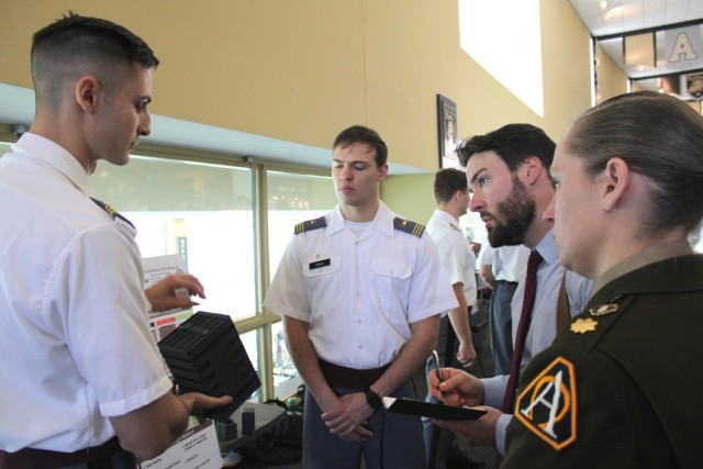 WEST POINT, N.Y. - (from left) Cadet Mateusz Bojarczyk and Cadet Nicholas Remus discuss their project, “Redesign legacy packaging systems to improve logistics, mitigate supply chain risks, and reduce lifecycle cost,” as Martin Seiz, a...