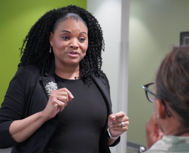 Dr. Regina Willis, Contractor Installation Manger with the JBM-HH Transition Assistance Program, explains the transition process to Col. Tasha N. Lowery, JBM-HH Commander, during an Open House event Apr. 24.