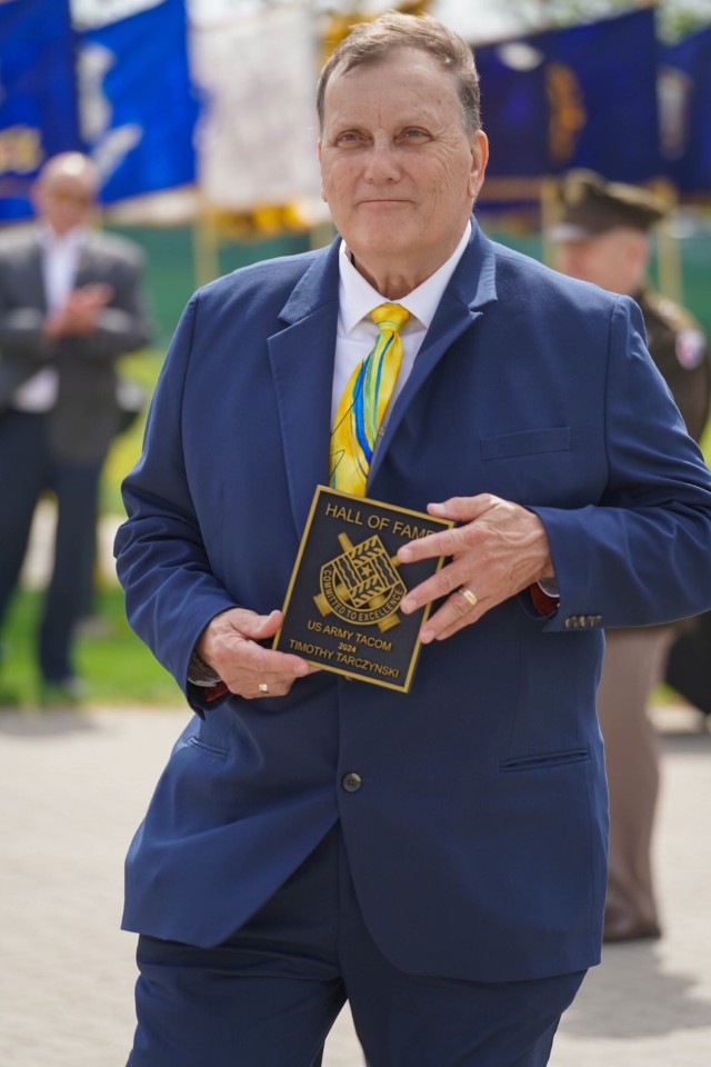 Timothy Tarczynski, former TACOM deputy chief of staff G-1, Human Capital, holds an award after being recognized at the April 29, 2025, TACOM Hall of Fame induction ceremony at the Detroit Arsenal.