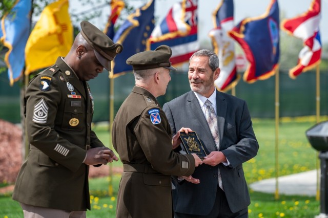 Jerry Figueroa receives an award from Maj. Gen. Michael B. Lalor, TACOM commanding general, during the April 29, 2025, TACOM Hall of Fame induction ceremony at the Detroit Arsenal.