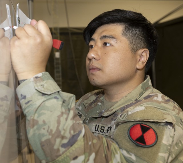 A Soldier from 7th Infantry Division practices writing symbols that would be used later during an IPOE Academy at Joint Base Lewis-McChord.