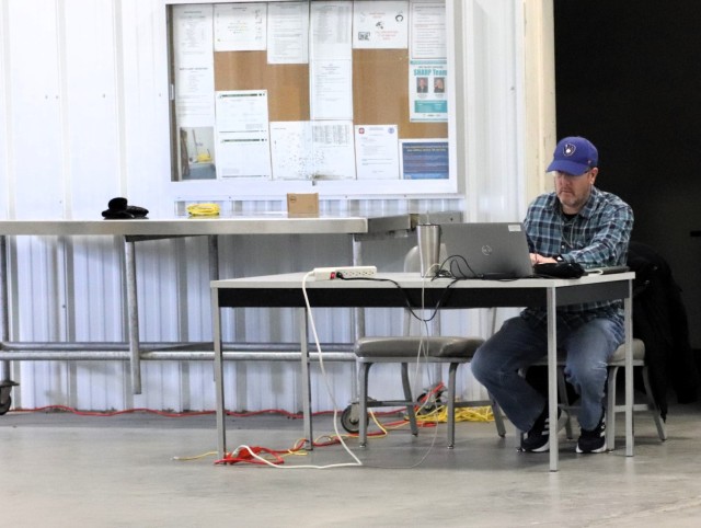 Garrison Information Management Officer Bob Pennebecker processes information Jan. 17, 2025, in a warehouse at Fort McCoy, Wis., while managing an effort to collect old phones from across the installation. Old phones were collected by the Fort...