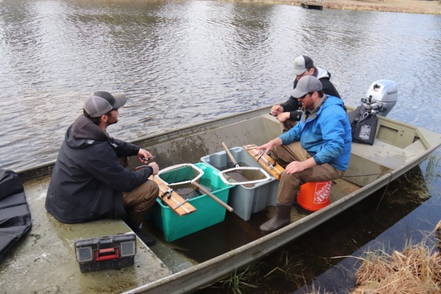 Watershed Management Biologist Derek Maki and Watershed Management Specialists Jaden Gallardo and Trenton Foreman with Colorado State University conduct a fish survey April 22, 2025, at Stillwell Lake on South Post at Fort McCoy, Wis. They...