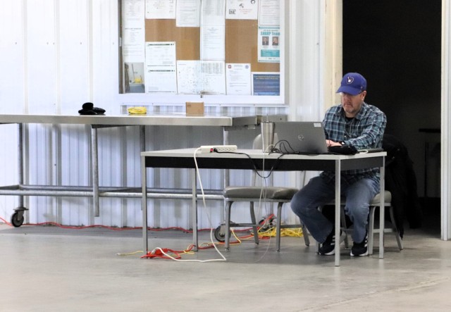 Garrison Information Management Officer Bob Pennebecker processes information Jan. 17, 2025, in a warehouse at Fort McCoy, Wis., while managing an effort to collect old phones from across the installation. Old phones were collected by the Fort...