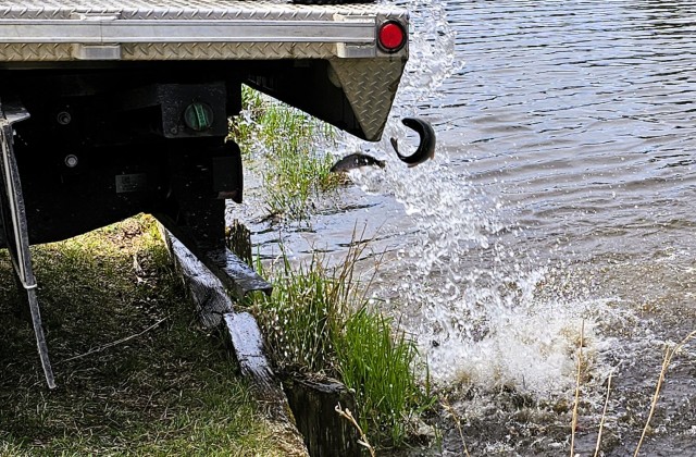 U.S. Fish and Wildlife Service (USFWS) employees stock rainbow trout April 23, 2025, in Suukjak Sep Lake on North Post at Fort McCoy, Wis. Approximately 15,000 rainbow trout were stocked at several lakes and ponds at Fort McCoy by the USFWS Genoa...