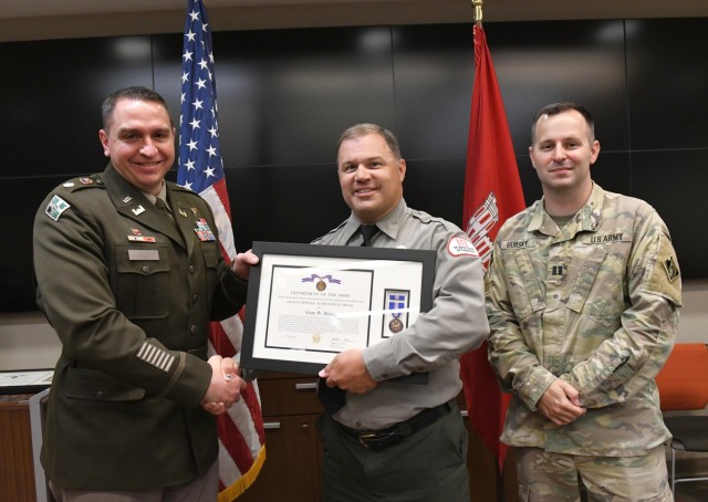 Lt. Col. Robert Green, U.S. Army Corps of Engineers Nashville District commander, left, presents the Department of the Army Civilian Service Achievement Medal to Conservation Biologist Gary Bruce of Center Hill Lake as Capt. Matthew Gursky, right,...