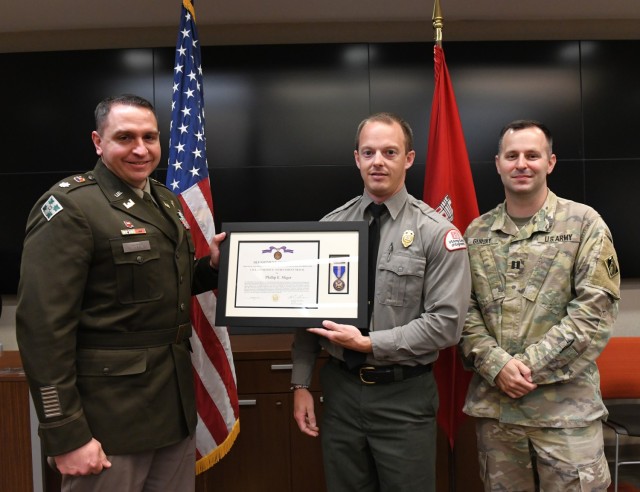 Lt. Col. Robert Green, U.S. Army Corps of Engineers Nashville District commander, left, presents the Department of the Army Civilian Service Achievement Medal to Natural Resources Specialist Phillip Sliger of Center Hill Lake as Capt. Matthew...
