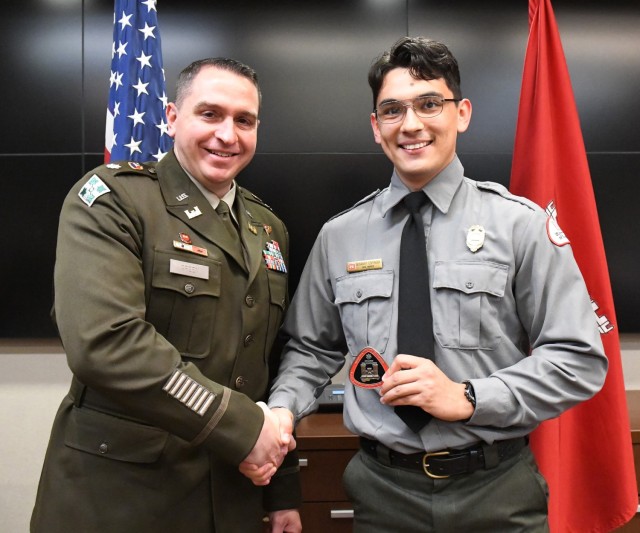 Lt. Col. Robert Green, U.S. Army Corps of Engineers Nashville District commander, left, presents a commander’s coin to Park Ranger Giovanny Espinoza of Old Hickory Lake May 5, 2025, in Nashville, Tenn. Espinoza was recognized for developing a...