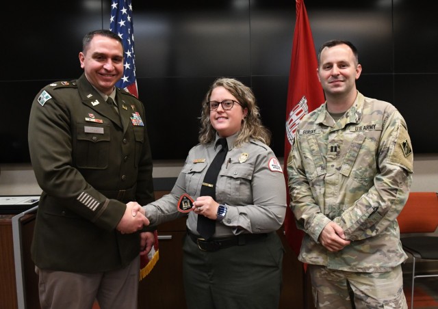 Lt. Col. Robert Green, U.S. Army Corps of Engineers Nashville District commander, left, presents a commander’s coin to Environmental Protection Specialist Ashley Webster of Cordell Hull Lake as Capt. Matthew Gursky, right, looks on May 5, 2025,...