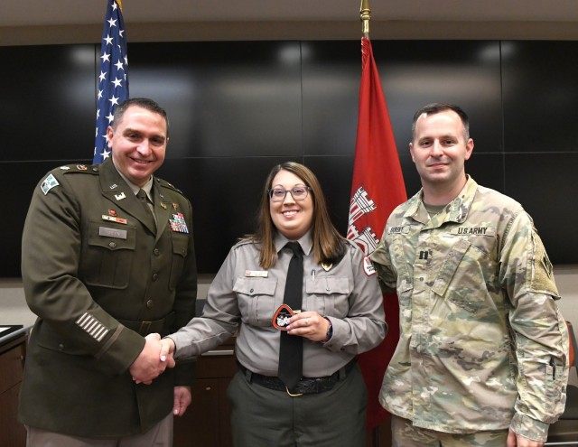 Lt. Col. Robert Green, U.S. Army Corps of Engineers Nashville District commander, left, presents a commander’s coin to Conservation Biologist Emily Johnson of Old Hickory Lake as Capt. Matthew Gursky, right, looks on May 5, 2025, in Nashville,...