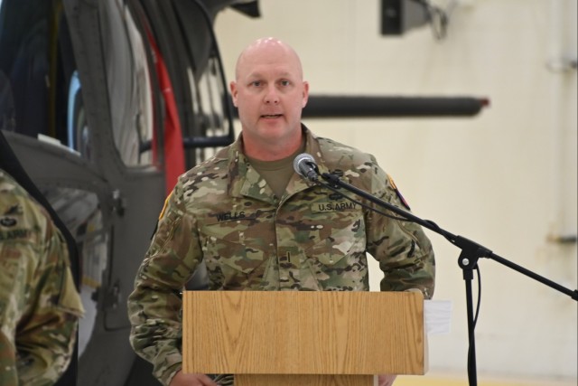 Chief Warrant Officer 5 Ryan Wells (right), new commander of the U.S. Army Special Operations Aviation Command Flight Detachment at Yuma Proving Ground, speaks at the ceremony following his assumption of command on May 8, 2025.