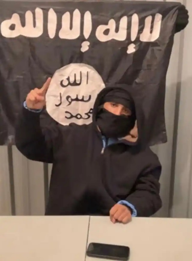 A video still from the federal complaint of Ammar Abdulmajid-Mohamed Said in front of an ISIS flag