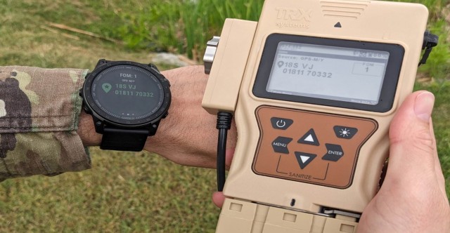 A Soldier holds a DAPS GEN II in one hand while wearing a watch in the other hand