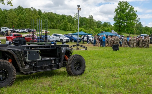 Soldiers and technology developers discuss their assessments of a robotically controlled utility terrain vehicle being tested May 13 at Fort Leonard Wood’s Training Area 401.
