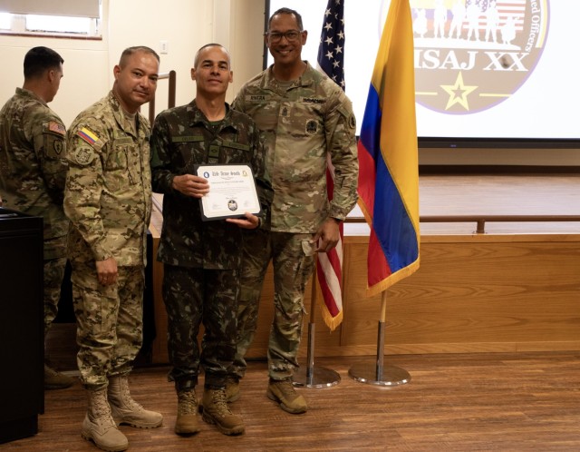Command Sgt. Maj. of the Colombian army (COLAR) Diego F. Rodriguez and Sgt. Maj Ottoniel Rivera, the U.S. Army South, Security Cooperation Directorate Senior Enlisted Leader, present certificate to Brazilian army student, during the Programa...