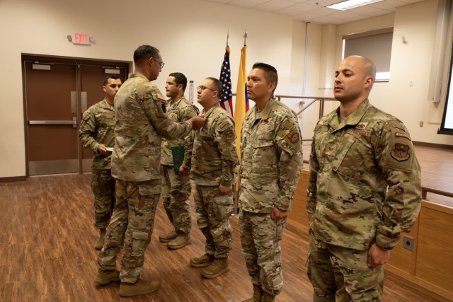 Sgt. Maj Ottoniel Rivera, the U.S. Army South, Security Cooperation Directorate Senior Enlisted Leader, pins awards to supporting Airmen assigned to Inter-American Forces Academy, 37th Training Wing, during the Programa Integral para Suboficiales...