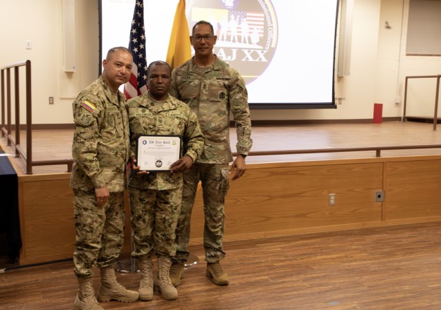 Command Sgt. Maj. of the Colombian army (COLAR) Diego F. Rodriguez and Sgt. Maj Ottoniel Rivera, the U.S. Army South, Security Cooperation Directorate Senior Enlisted Leader, present certificate to a Colombian army student, during the Programa...