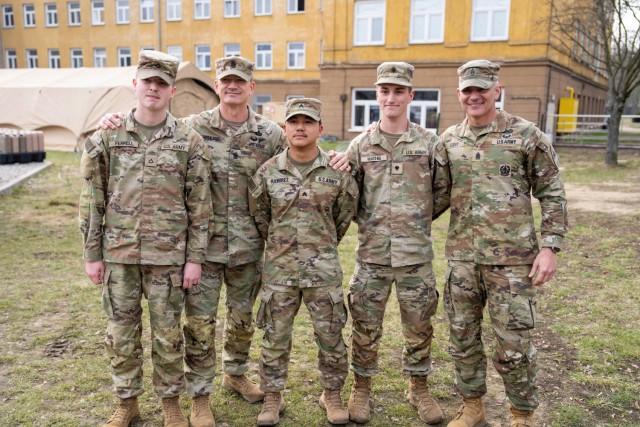 Command Sgt. Maj. TJ Holland, second from left, U.S. Army Forces Command's senior enlisted leader, and Command Sgt. Maj. James L. Light, far right, 1st Armored Division's senior enlisted leader, visit with Soldiers from 1st Armored...