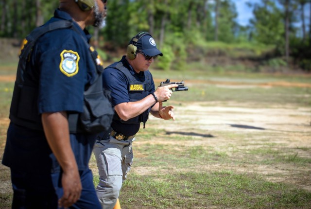 Sgt. Andrew Justice with the Richmond County Marshal's Office advances to his next firing position during the Combat Pistol Course as part of the National Police Week shooting competition at Range 8 on Fort Eisenhower, May 13, 2025.